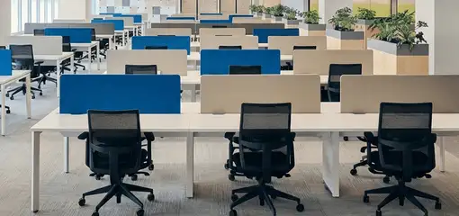 Modern open-plan office space featuring clean workstations, ergonomic chairs, and sanitized carpets provided by professional office cleaning services in Tempe, AZ.